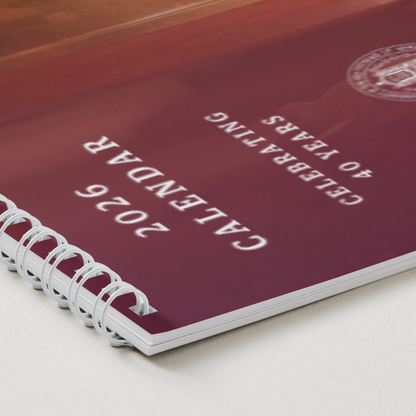 Maroon calendar with white text on a white surface